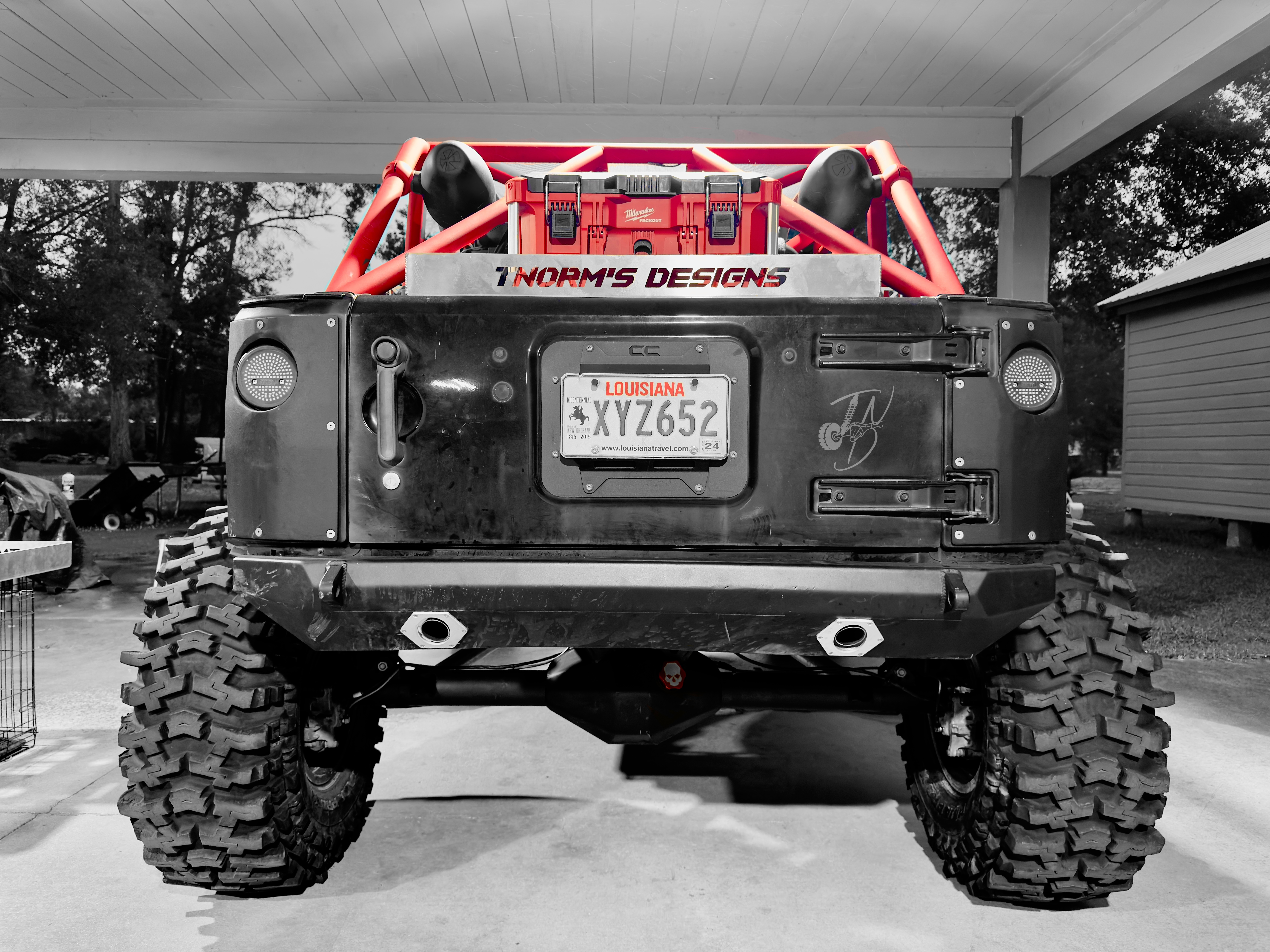 Rear view of Project Dynamite with its red cage and TNorm’s Designs branding