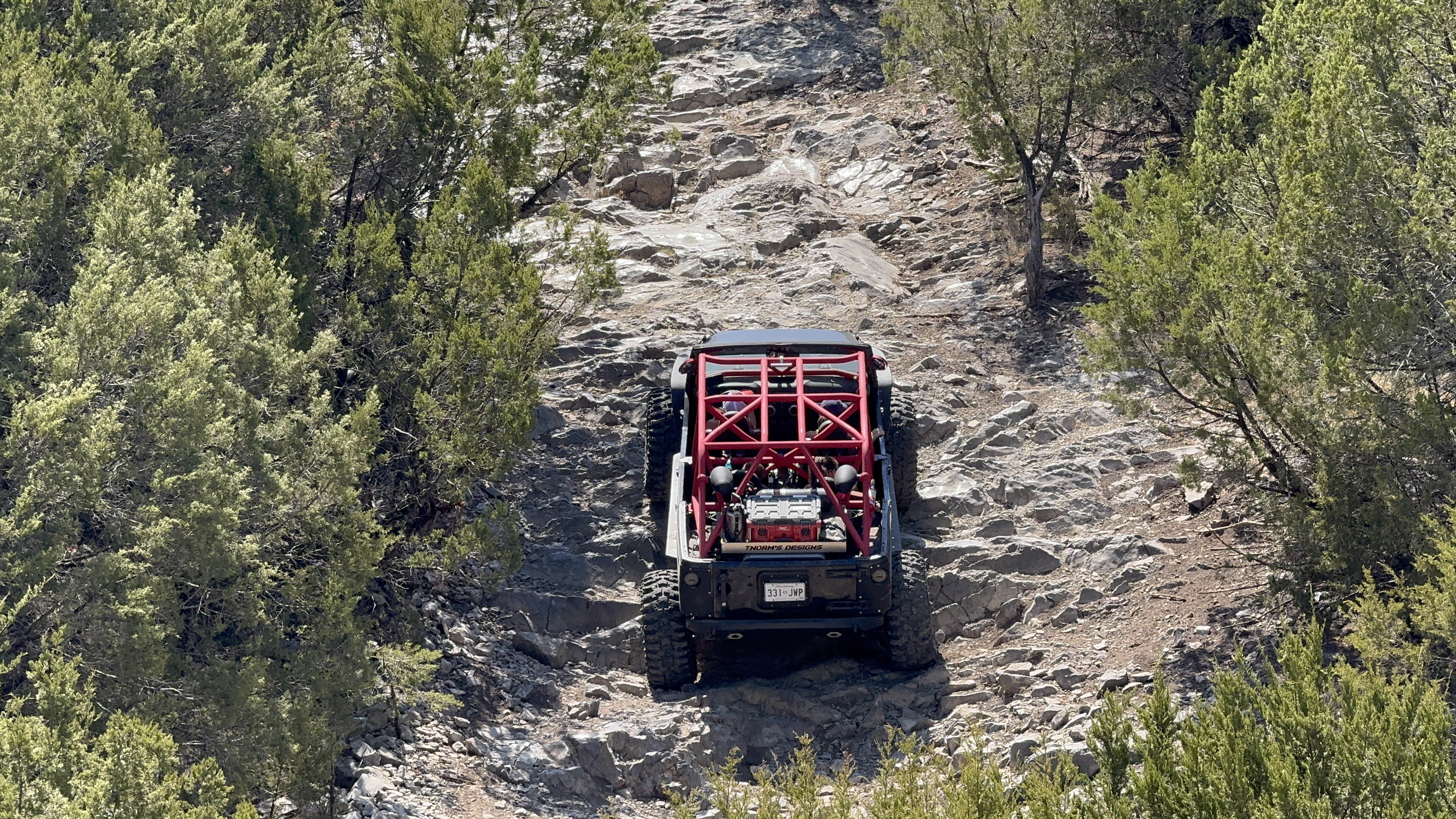Rear view of Project Dynamite climbing a rocky trail
